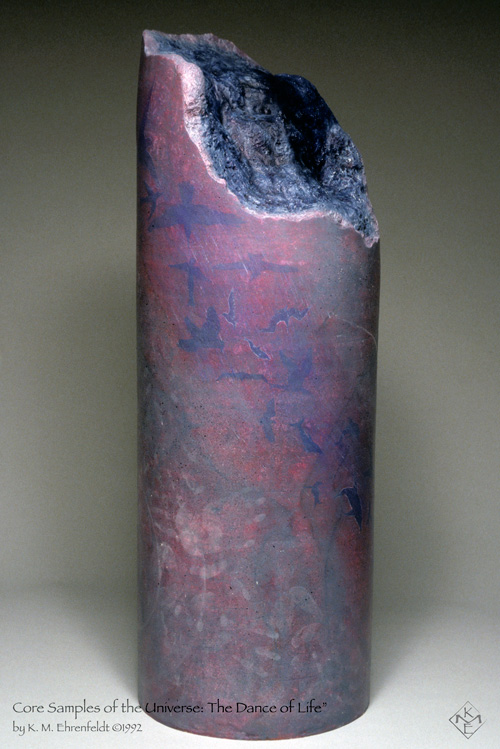 This upright painted column, with broken top angling from upper left down to the right, reveals the undulating night sky quality of the interior of the Core Sample's nature. The outer surface of the Core Sample is smooth, with transparent washes of grays, magenta, violet, and blue hues over a foundation that appears marble stone-like. In transparent effects, blue pigments form silhouettes of birds in various angles of flight descending diagonally across from the upper left to the lower right middle. As the bird silhouettes descend, they evolve into dolphin shapes. On either side are bands of stone-like gray marbling. Filling the bottom left area is a field of overlapping transparent white hand prints.