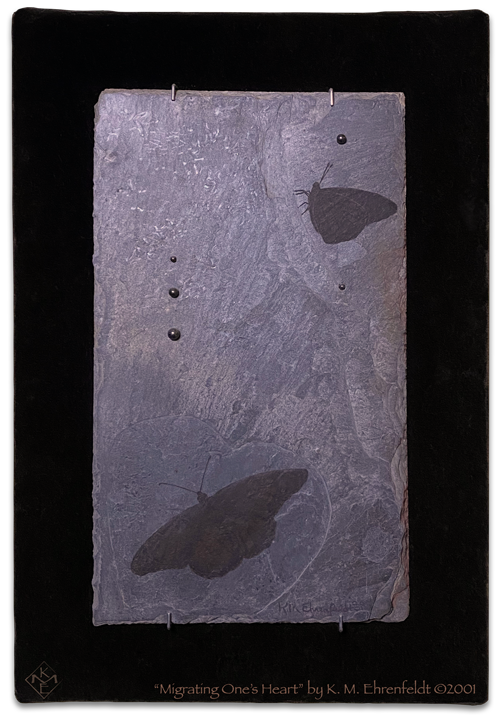 Dark monarch butterfly on etched heart in the weathered slate tile, and another monarch above; with hematite droplets rising and falling on the slate, with background of black velvet.