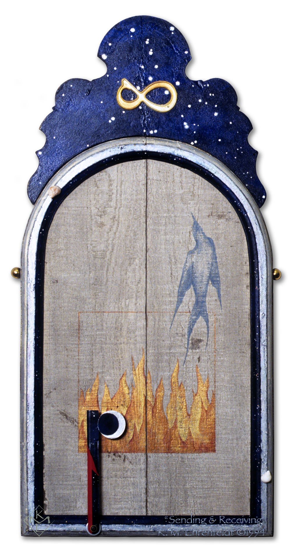 Painted smoke bird rises above flames on white-washed recycled barn wood in an old silver leaf mirror frame with painted embellishment above featuring a golden lemniscate on a night sky. Two sea snail shells traverse frame edge, while a steel mail flag with waxing crescent moon as the flag itself, can be positioned to point red arrow in sending or receiving direction.