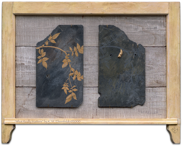 A diptych of etched and painted weathered slate tiles, has gold leaf imagery of cocoon and leafy branch, with treatment reversed on each slate. Slates are positioned side by side on recycled barn wood backing within a used wooden window frame that has been gold leafed.