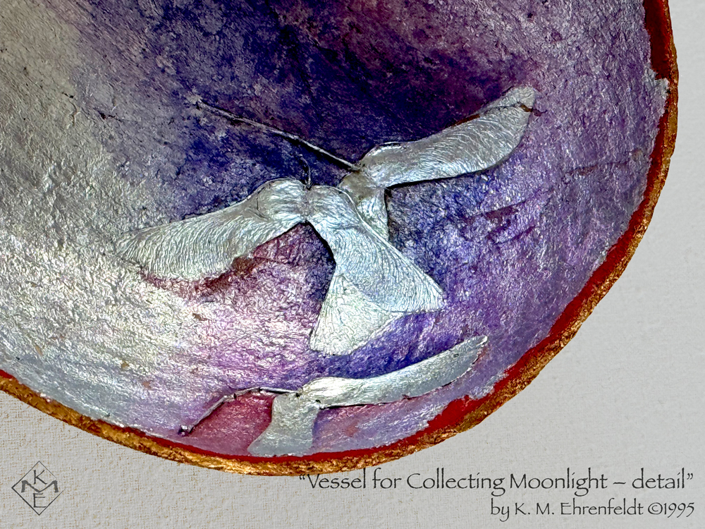 About a quarter of the vessel is visible, showing one end. The concave silver surface has a translucent blue violet wash toward the inside rising to a magenta at the upper edges of part of the vessel. The rim is stained gold and vivid red. Interlaid inside the vessel are three silver maple seed pods that look like outspread wings.