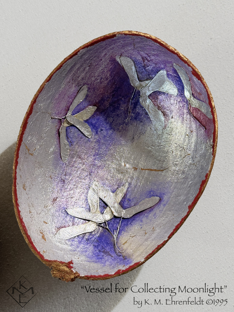 An interior view of the whole vessel is visible. The concave silver surface has a translucent blue-violet wash in a few areas as well as a faint magenta wash at some of the upper edges. The rim is stained gold and vivid red. Interlaid inside the vessel are groupings of silver maple seed pods that look like outspread wings.