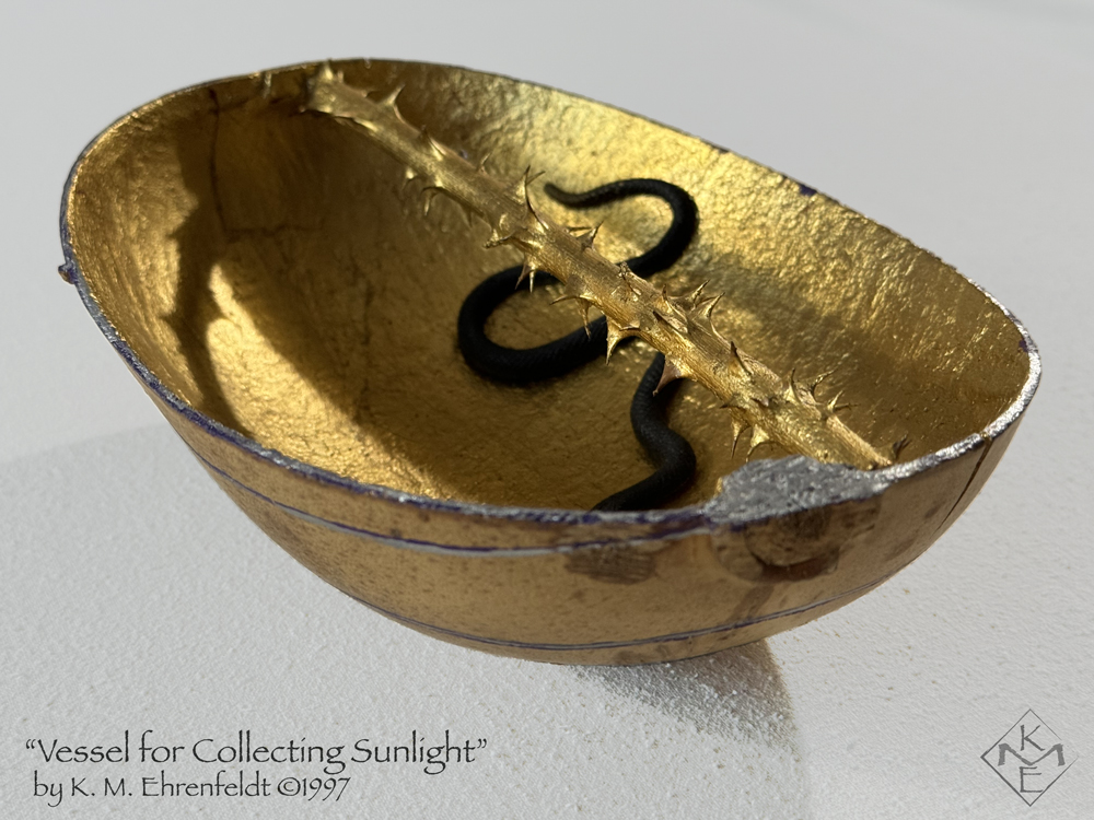 The vessel in side view shows the raw amber outer surface of the gourd and the gold-leaf interior with a thorny gold-leafed rose stem bisecting the gourd lengthwise across the top from stem to base. a black snake curves across the bottom of the interior.
