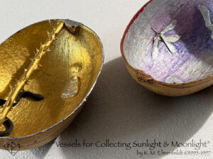 The Sun Vessel in partial view on the left half of the image and the Moon Vessel in partial view at the upper right. Sun vessel has a gold-leafed interior with a thorny gold-leafed rose stem bisecting the gourd lengthwise across the top from stem to base. A black snake enters from the lower left curving across the bottom toward the center. On the opposite side of the thorny rod above, a clear glass triangle rests inside, pointing upward, and resembles a puddle of light. A raised bump is visible above the puddle of light. The rim of the vessel is a deep blue and silver. An interior view of the Moon Vessel reveals the concave silver surface having a translucent blue-violet wash in a few areas as well as a faint magenta wash at some of the upper edges. The rim is stained gold and vivid red. Interlaid inside the vessel are groupings of silver maple seed pods that look like outspread wings. Glimpses of the external sides beneath are visible, showing the raw amber surface of the gourds with some lines and script partially visible.